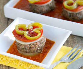 Layered patties and vegetables with bell pepper sauce