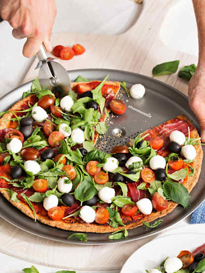 Pizza integral con tomates cherry, rúcula y mozzarella fresca