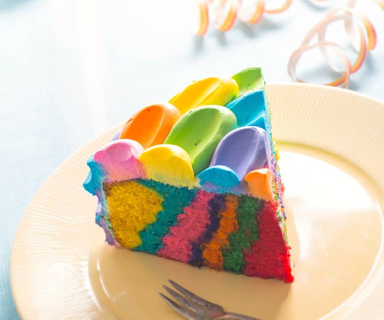 Spring rainbow cake with bright cheerful flowers and fluffy clouds