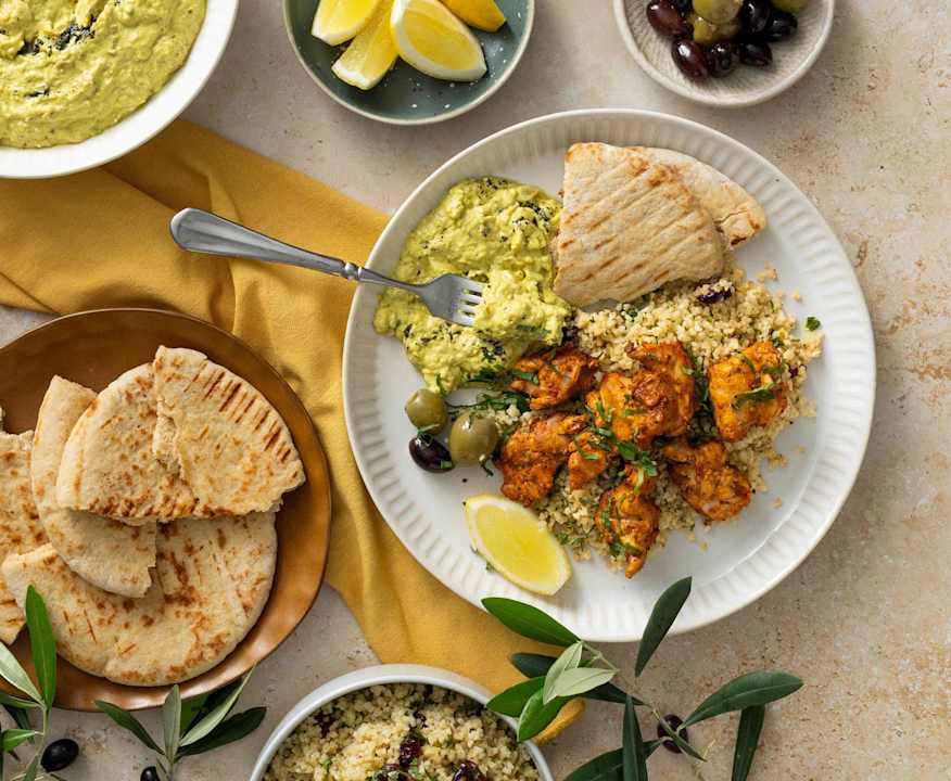 Mezze spread: eggplant dip, bulgur salad, harissa grilled chicken ...