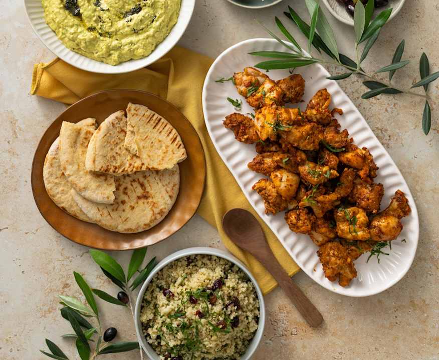 Mezze spread: eggplant dip, bulgur salad, harissa grilled chicken ...
