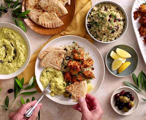 Mezze spread: eggplant dip, bulgur salad, harissa grilled chicken ...